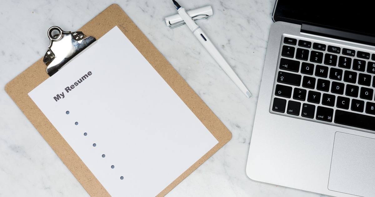 Job seeker editing resume bullet points on a laptop