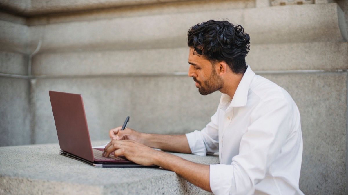 A calm person working independently at a tidy, well-organized desk