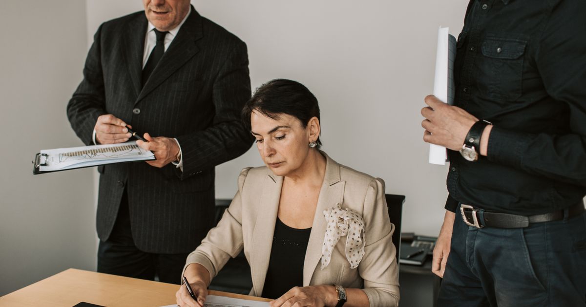 Mature professionals reviewing documents together in an office