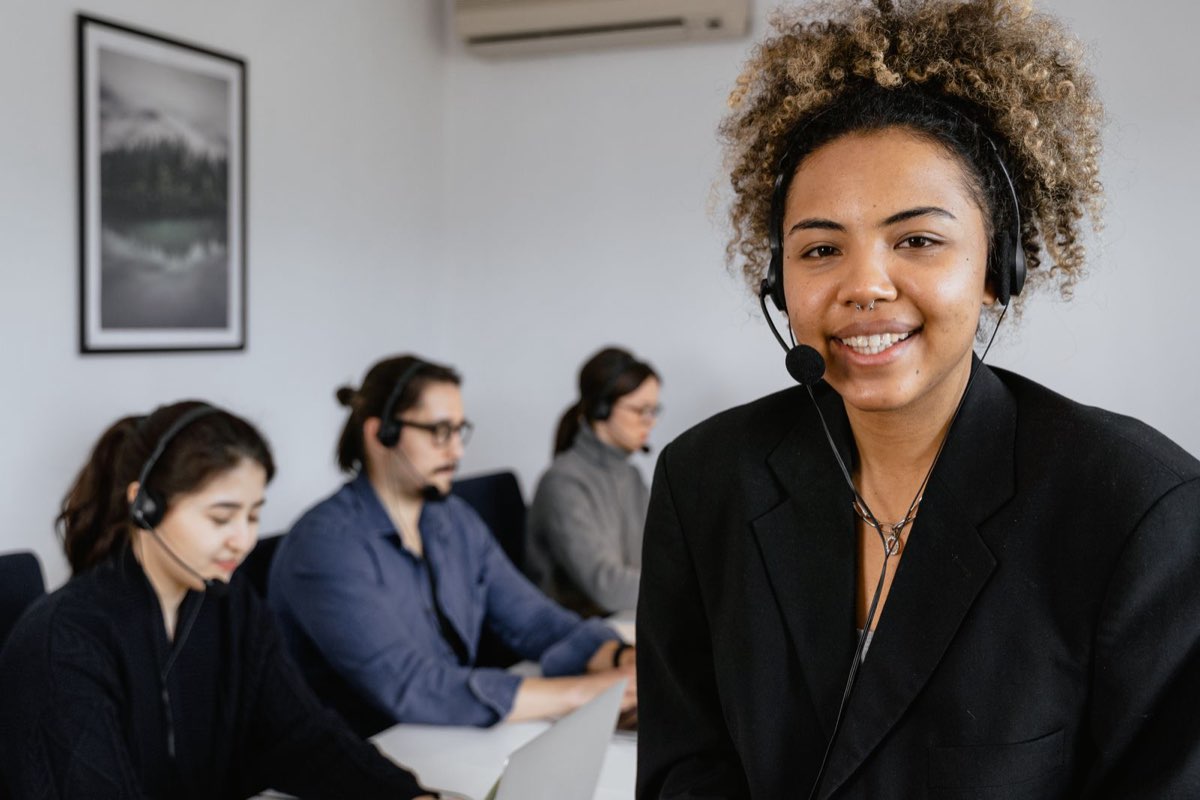 Customer service representative wearing a headset at a desk