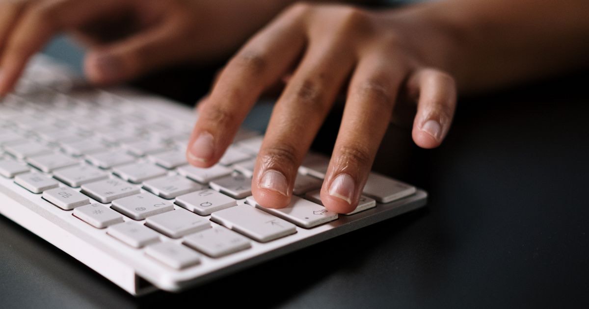 Job seeker checking an inbox and writing a follow up email after an interview