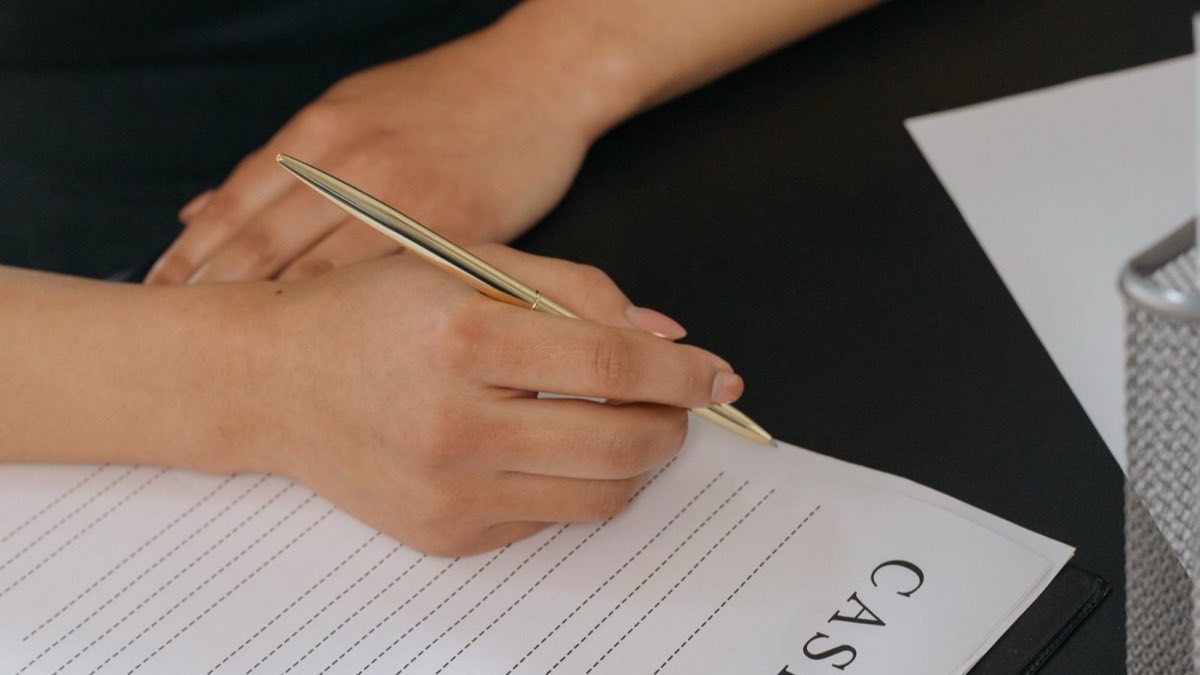 Job seeker checking a printed resume against a checklist before applying