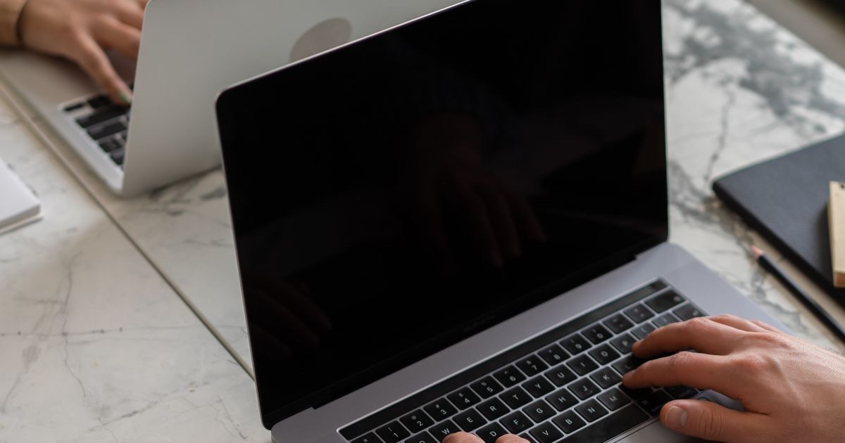 Professional writing a polite email to decline a job offer