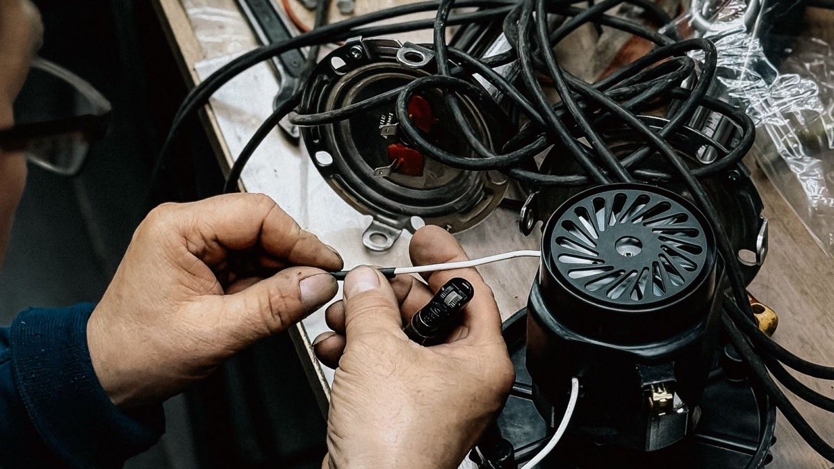 Maintenance technician repairing an HVAC unit with a wrench and a work order clipboard