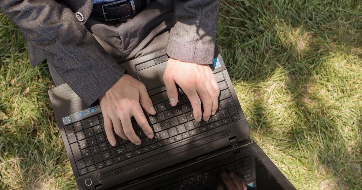Candidate typing a thank you email after an interview on a laptop
