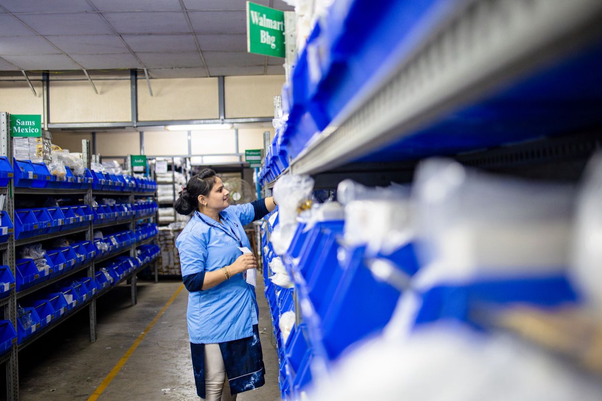 Warehouse associate moving boxes in a distribution centre